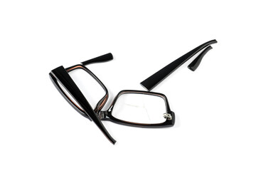 Broken eyeglasses isolated on white, above view