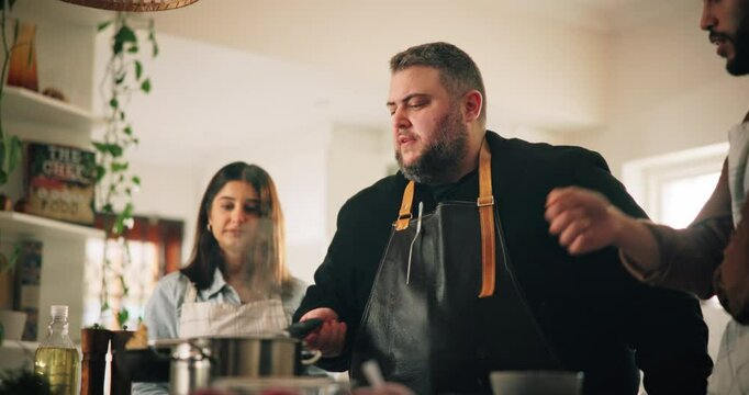 Cooking, couple and learning with chef in kitchen for demonstration or preparation of meal. Cuisine, culinary and recipe with people at counter in class for lesson on diet, health or nutrition