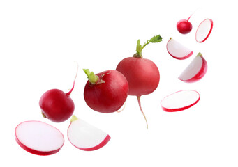 Fresh ripe radishes falling on white background