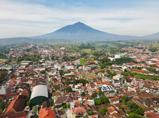 Aerial view of the residential area and its surroundings of ​​Garut city with Mount Cikuray in the background and the Cimanuk River also visible. Garut is a district in West Java, Indonesia.