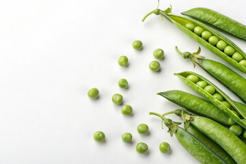 A bunch of green peas are on a white background