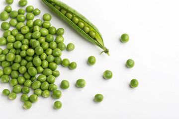 A bunch of green peas and a pea pod on a white background
