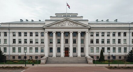 Obraz premium Aerial view of a large white neoclassical building with a flag on top and many windows and columns