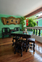 Elegant Baba Nyonya Wooden Tea Table and Chairs on a Traditional Balcony
