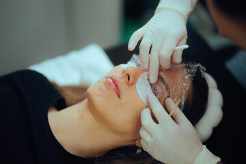 Beautician Prepares Eyelashes for the Lamination Procedure at the Salon. Woman goes to a beauty...