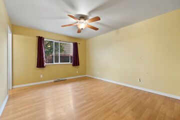 Spacious living room with wooden flooring and sliding doors leading to a bright outdoor area