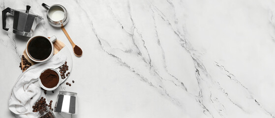 Geyser coffee maker with cup, jug of milk, powder and beans on marble background