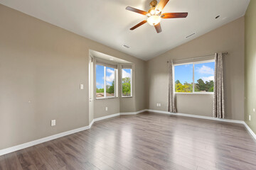 Spacious living room with wooden flooring and sliding doors leading to a bright outdoor area