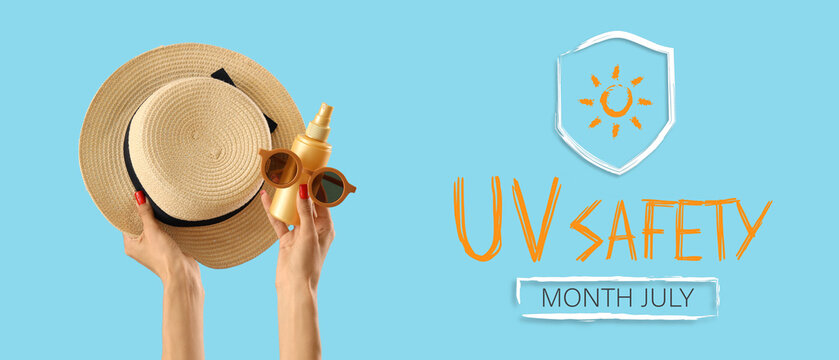 Female hands with hat, sunglasses and sunscreen cream on blue background