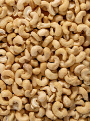 peeled cashew nuts scattered all over the frame. cashew nuts background