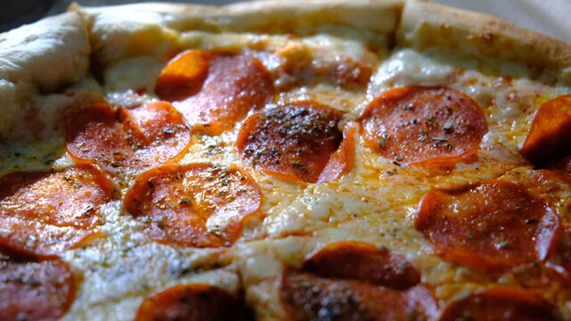 Hot Spicy Pizza with chilli pepper, salami, mozzarella cheese and tomato ketchup,  restaurant food. Sunlight