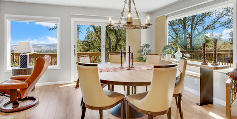 A beautifully decorated dining room with a round table and chandelier