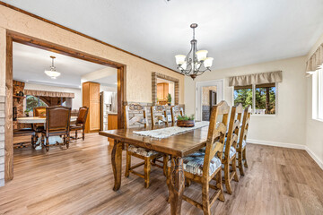 Beautiful dining room with wooden table, chairs, and chandelier