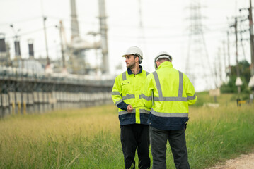 Engineer worker in protective uniform talking with colleagues at construction site