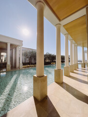 Serene Poolside View with Sunlight and Elegant Architecture