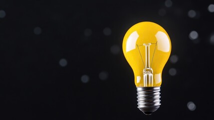 Single, bright yellow light bulb against a dark background