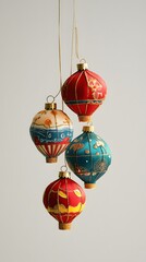 Four painted lantern Christmas ornaments