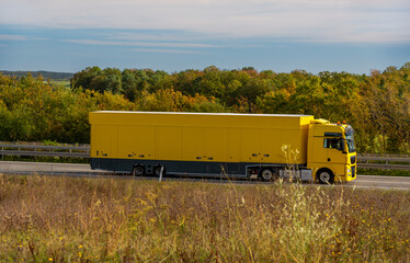 Truck driving on the highway in autumn scenery in Germany.