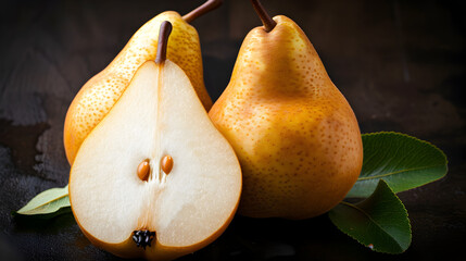 A pear is cut in half and has a leaf on top