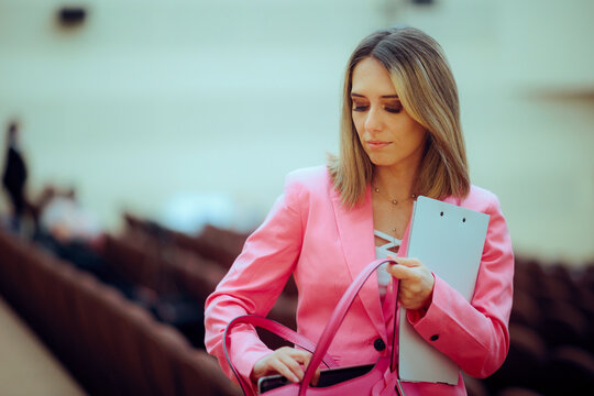 Woman Attending a Conference Searches in her Bag. Disorganized person trying to find something in their own purse  - Powered by Adobe