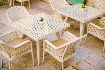 Outdoor Dining Set with White Rattan Chairs and Tables