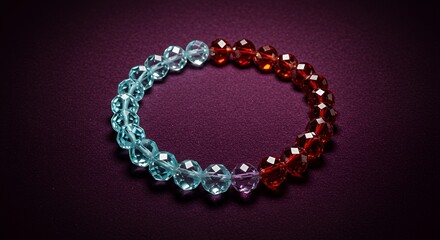 Obraz premium Beaded Bracelet Displayed on Dark Surface Featuring Blue and Red Faceted Beads
