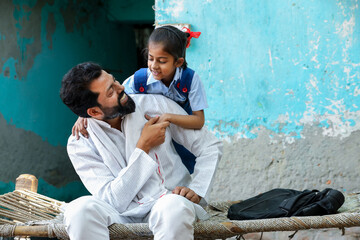 Happy rural indian father and little daughter in school uniform hug love and bonding. Parenthood, Education.