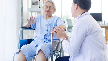 Fototapeta premium Asian man doctor with happy old woman patient sitting smile near window in nursing home hospital, consultation caregiver helping support healthcare to elderly senior medicals recovery service wellness