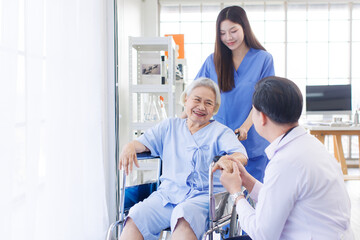Obraz premium Asian old woman sitting smile with doctor and caring nurse near window in nursing home hospital, consultation caregiver helping support healthcare to elderly senior medicals recovery service wellness.