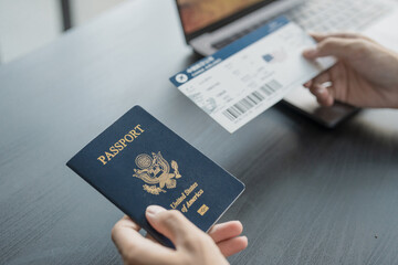 Hand Man Online booking and buying plane tickets using laptop phone and credit card Planning trip...