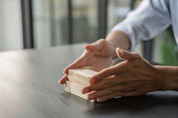 Planning risk and strategy in businessman gambling placing wooden block.Business concept for growth...