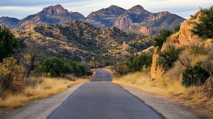 Winding Road with Majestic Mountains in Background © MD