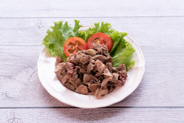 The pork meat is cooked and placed on a plate.