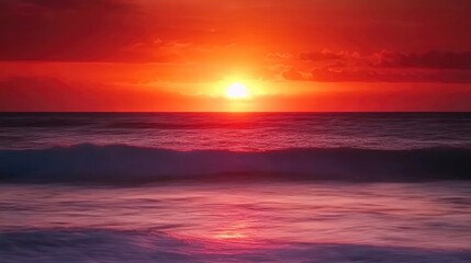 Obraz premium Long exposure of a red and orange sunset over the ocean