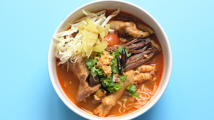 rice vermicelli with northern thai curry sauce on blue background