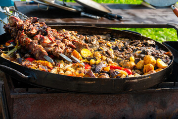 Grilled Meat Skewers and Roasted Vegetables on Open Fire