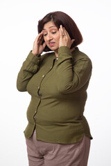 Indian senior sick woman suffering a bad headache. Indoor studio shot isolated on white background.