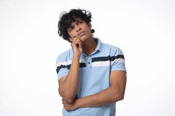 Indian over think  teenager standing over white background afraid and shocked, surprise and amazed...