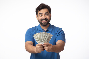 Indian happy excited man showing currency on white background.