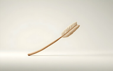 Elegant feather quill pen poised against a blank background, symbolizing creativity and writing.