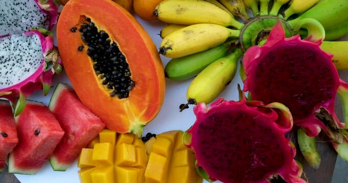 Exotic tropical fruits on the market. Edible bright fruity summer background. Fruit growing, gardening and agriculture. Panoramic movement. High quality FullHD footage