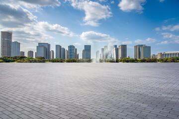 Modern Urban Skyline with Fountain Against a Bright Sky