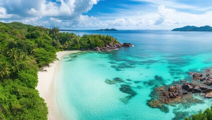 Fototapeta premium Serene Tropical Beach with Turquoise Water and Lush Green Vegetation Under a Bright Blue Sky with Puffy Clouds