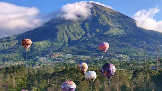 Hot air balloon festival in Indonesia, with majestic mountain in background