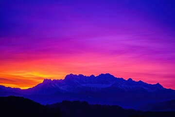 Fototapeta premium Mountains meet vibrant sky at twilight