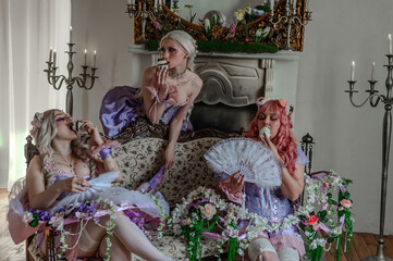 A girl dressed in the style of a Victorian boudoir, in a corset and crinoline of lilac color, in flowers