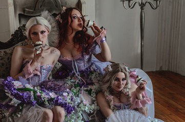 A girl dressed in the style of a Victorian boudoir, in a corset and crinoline of lilac color, in flowers