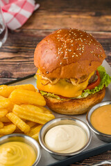 Smash burger with crispy onions served with fries and sauces