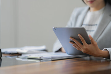 Close up of businessperson using tablet working with digital data