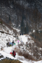 winter in the mountains, nature photography, tourists walk along the mountain path